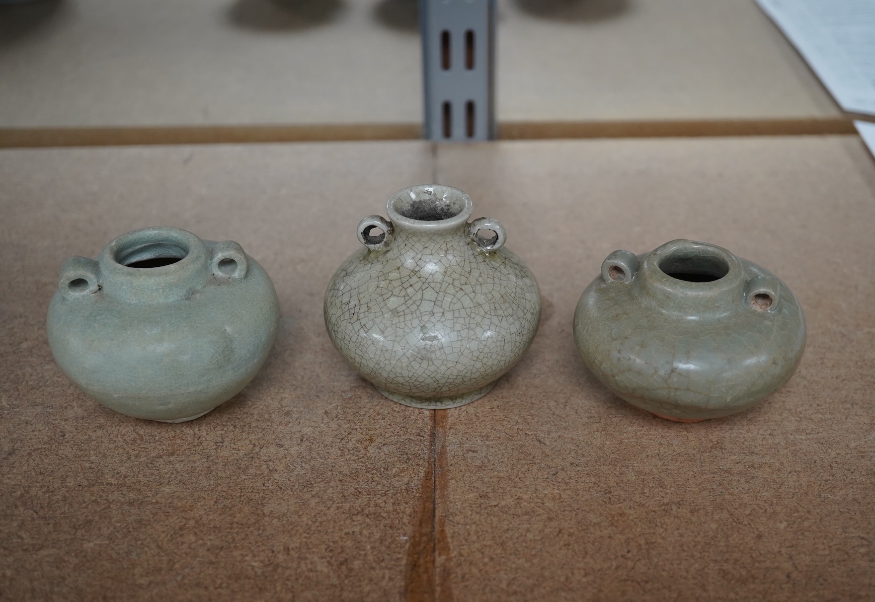 Two Chinese celadon jarlets, Yuan dynasty and a crackle glaze jarlet, tallest 6cm. Condition - good